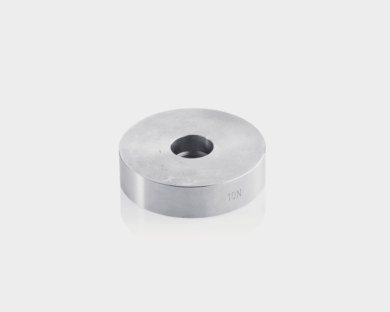 Increase in the compression force of the sample by 10 N for Abrasion Testing Machine